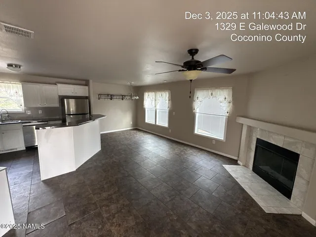 a view of a kitchen with microwave and cabinets