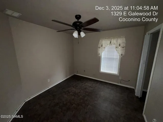 a view of a ceiling fan and wooden floor