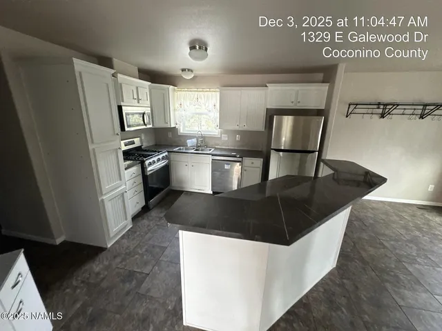 a kitchen with a stove a refrigerator and a sink