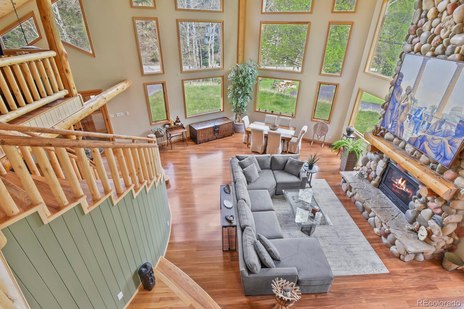 417 Witter Gulch Road Evergreen, CO 80439 - Photo 25 of 50 a living room with furniture and a floor to ceiling window