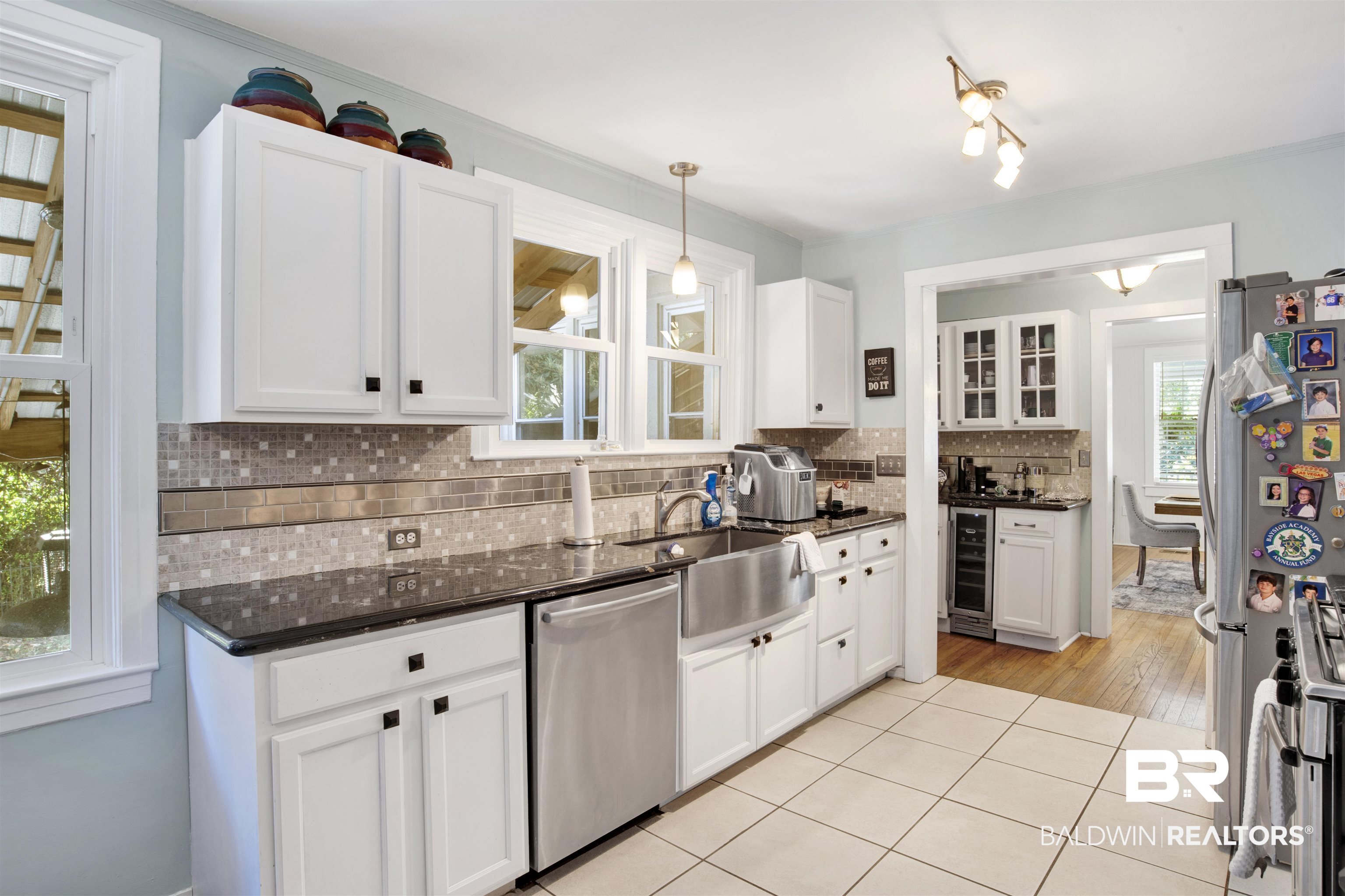 605 Van Avenue Daphne, AL 36526 - Photo 14 of 37 Kitchen with decorative backsplash, white cabinets, light hardwood / wood-style flooring, pendant lighting, and stainless steel appliances