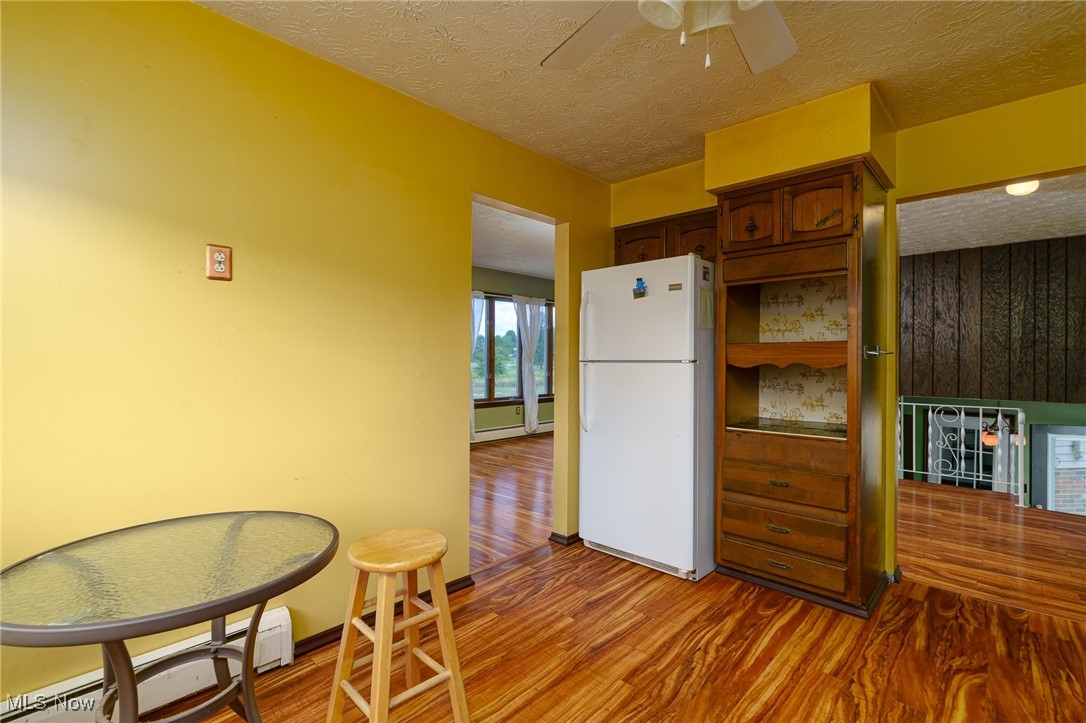 6747 Giddings Road Rootstown, OH 44272 - Photo 10 of 39 Kitchen featuring white appliances and entrance to dining room