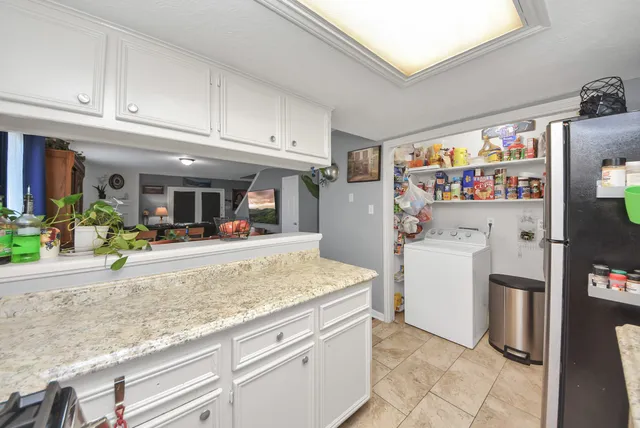 a kitchen with stainless steel appliances granite countertop a refrigerator and a sink