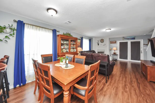 a view of a dining room with furniture window and wooden floor