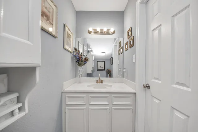 a bathroom with a sink vanity and a mirror