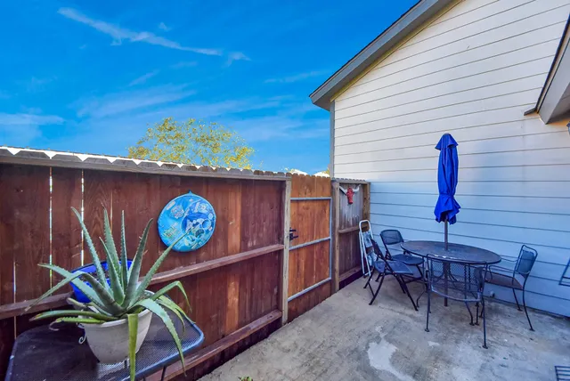 a view of a chairs and table in a backyard