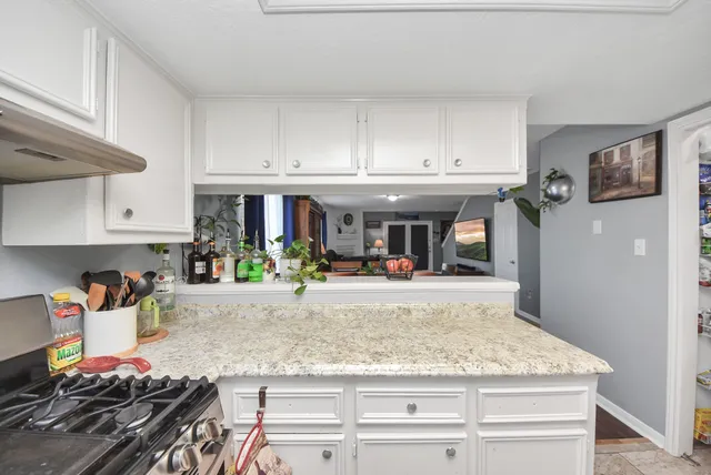 a kitchen with stainless steel appliances granite countertop a stove and a sink