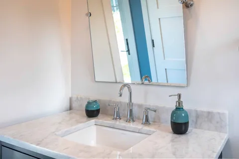 a bathroom with a sink and a mirror