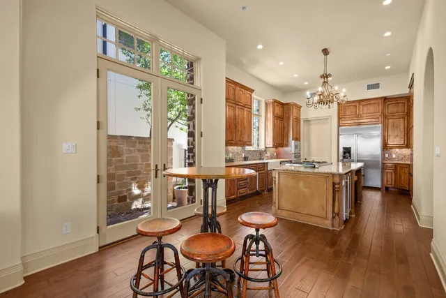 a large kitchen with a table and chairs