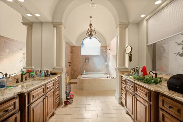 a bathroom with a tub sink and mirror