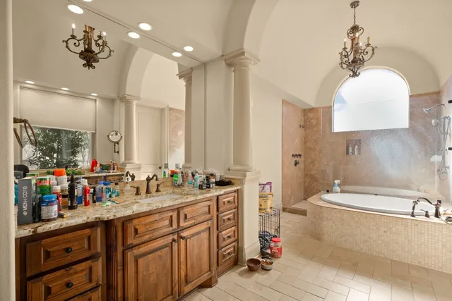 a bathroom with a double vanity sink mirror and bathtub