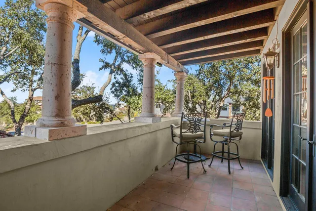 a view of a porch with chairs and backyard