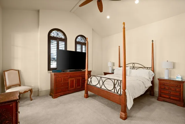 a bedroom with furniture and a flat screen tv