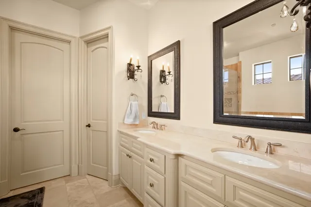 a bathroom with double vanity sinks and a mirror
