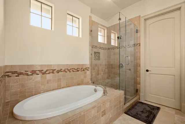 a bathroom with a bathtub and a shower