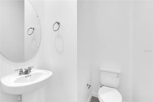 a bathroom with a sink a toilet and mirror