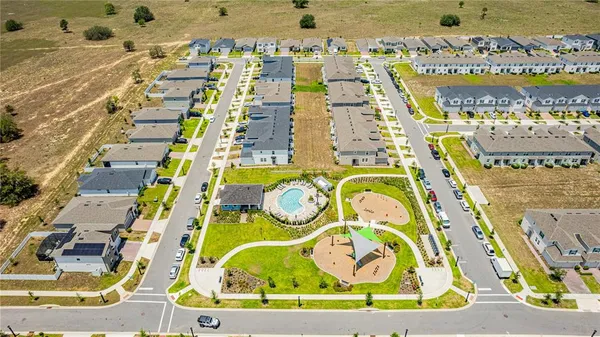 an aerial view of residential house with outdoor space swimming pool and seating area