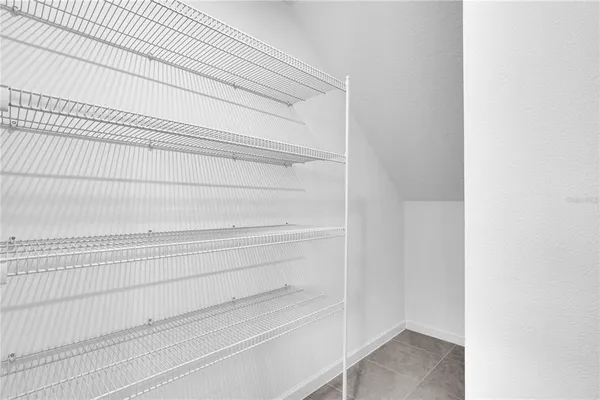 a large white kitchen with stainless steel appliances granite countertop a sink and cabinets