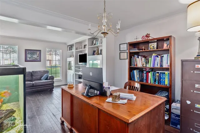a view of a workspace with furniture bookshelf and a window