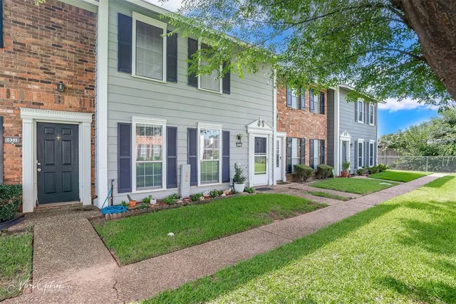 a front view of a house with a yard and table and chairs