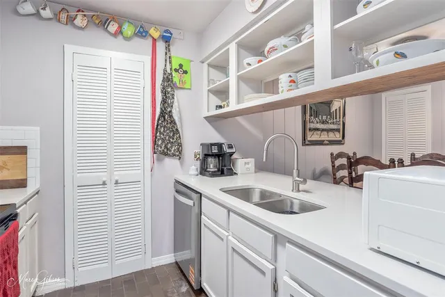 a kitchen with a sink cabinets and a window