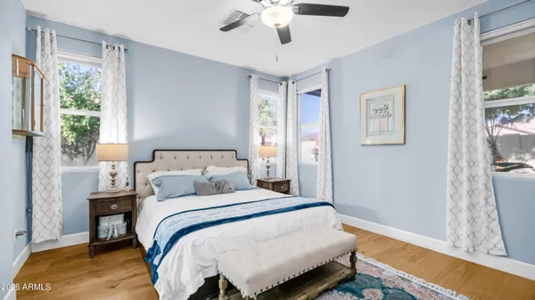 a bedroom with a bed and a chandelier