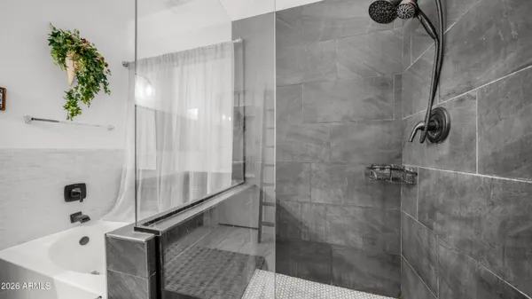 a bathroom with a shower and a tub