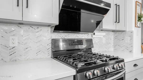 a stove top oven sitting inside of a kitchen
