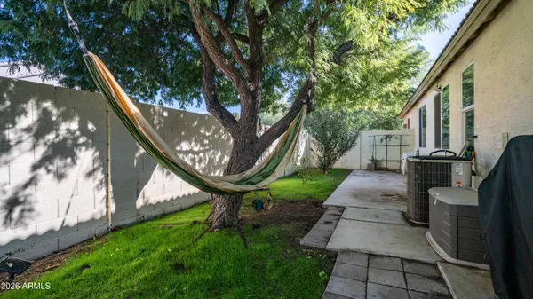 a view of a porch with furniture and a yard