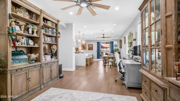 a living room with furniture and a book shelf