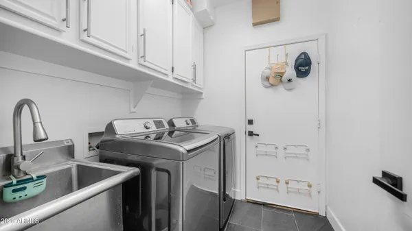 a kitchen with stainless steel appliances a sink a refrigerator and cabinets