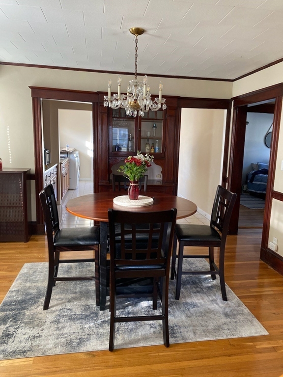 a dining room with furniture a rug and wooden floor