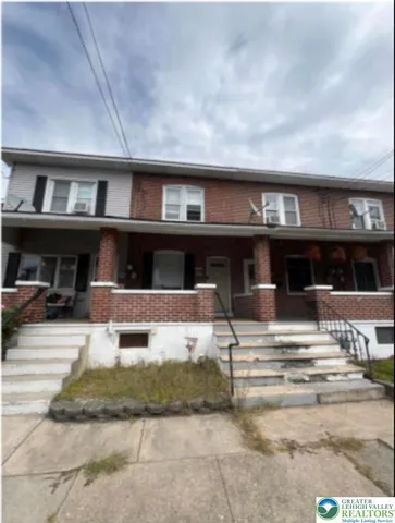 a view of building with car parked
