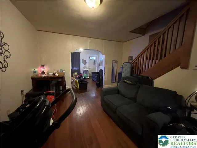 a living room with furniture and a gym equipment