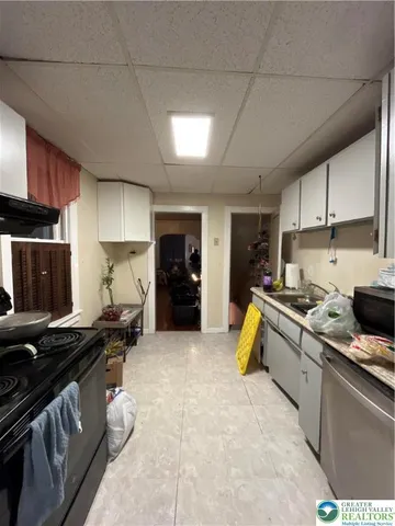 a kitchen with a stove a sink and a refrigerator