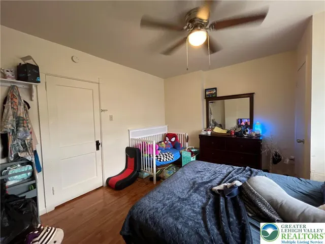 a bedroom with bed and a chandelier