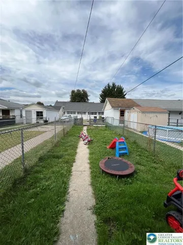 a view of swimming pool with a table and chairs