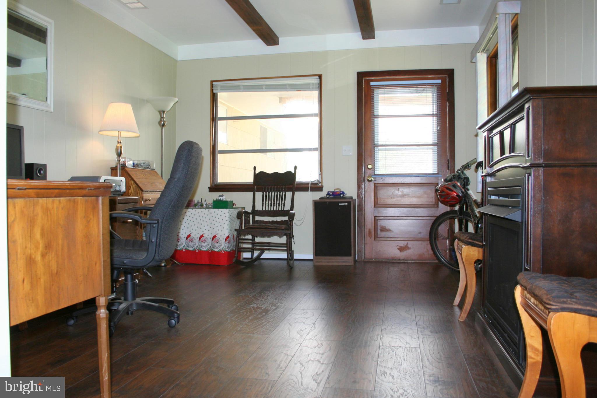 2514 Barrison Point Road Essex, MD 21221 - Photo 12 of 22 a view of a workspace with furniture and a window