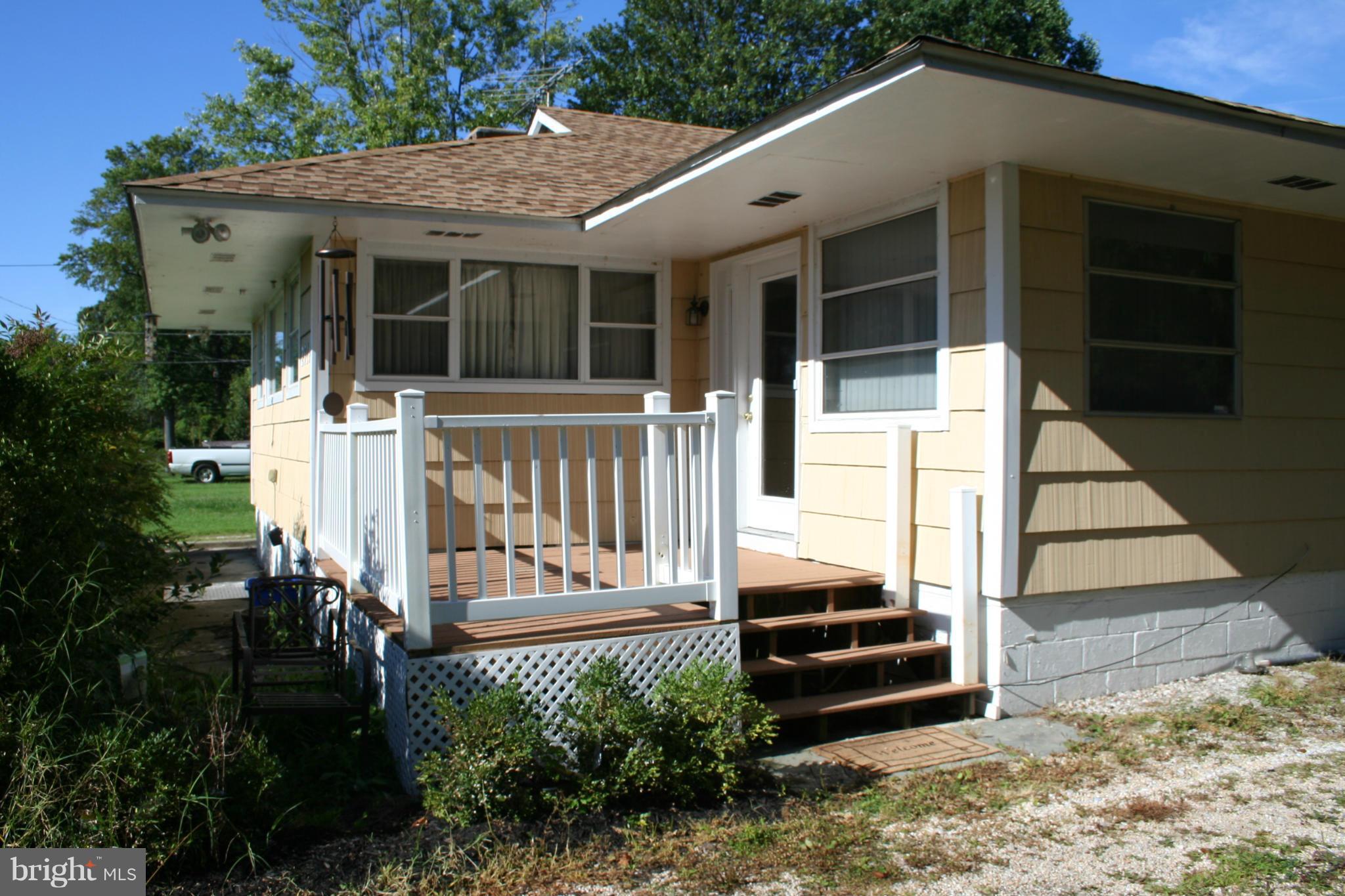 2514 Barrison Point Road Essex, MD 21221 - Photo 17 of 22 a view of a patio with table and chairs with wooden floor and fence