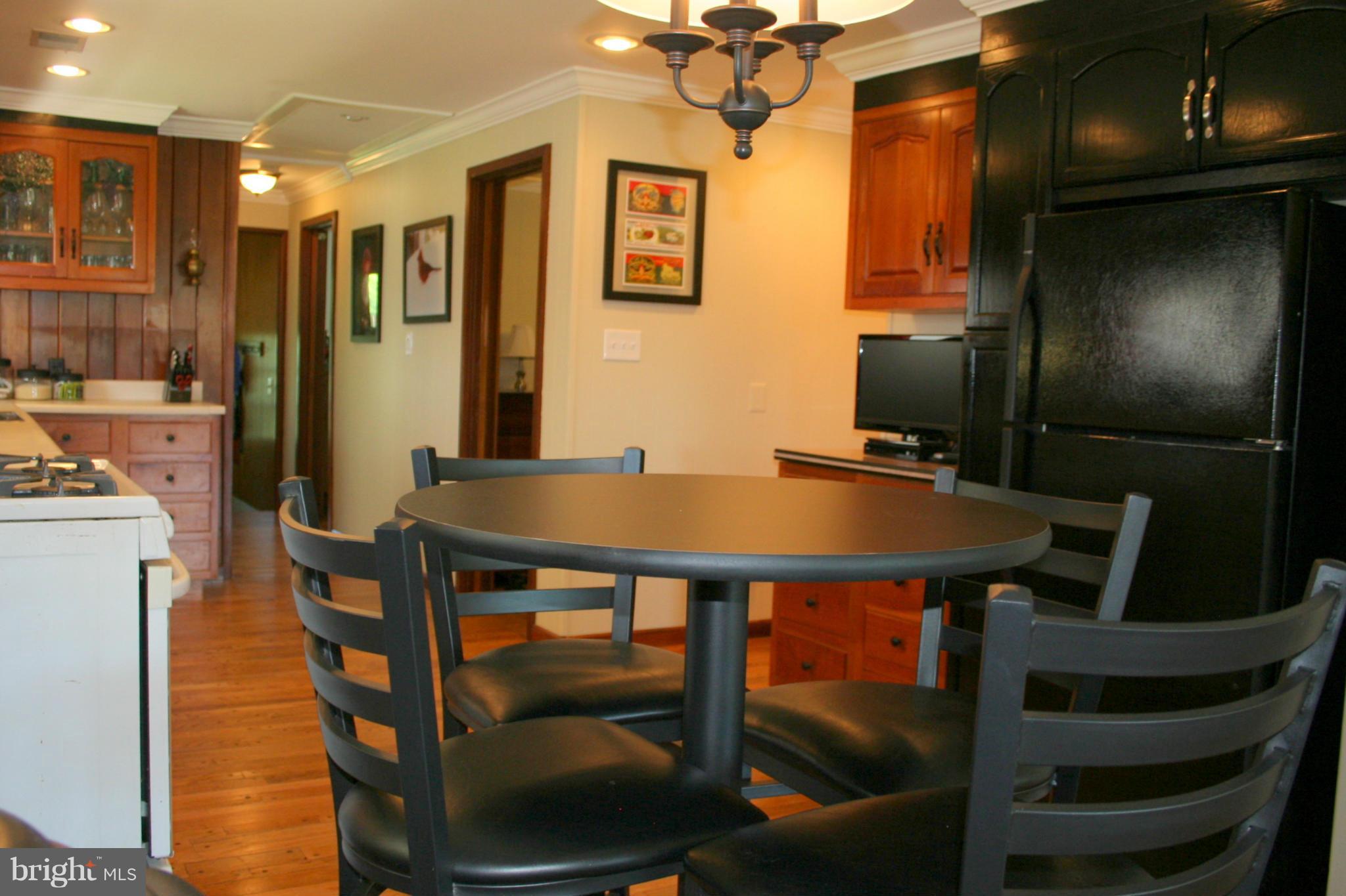 2514 Barrison Point Road Essex, MD 21221 - Photo 9 of 22 a view of a dining room with furniture and a chandelier