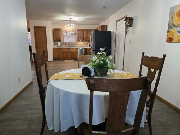 a dining room with furniture and wooden floor