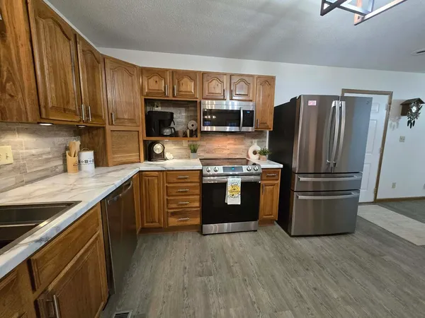 a kitchen with a refrigerator stove and sink