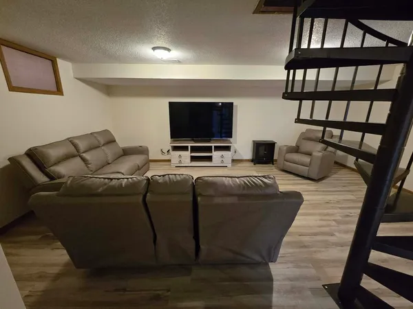 a bedroom with furniture and a gym equipment