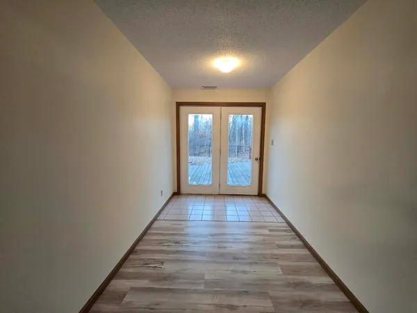 a hallway with wooden floor and furniture