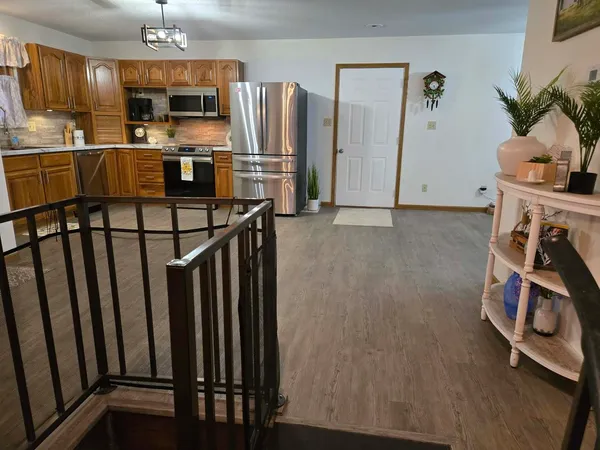 a kitchen with stainless steel appliances a refrigerator and microwave