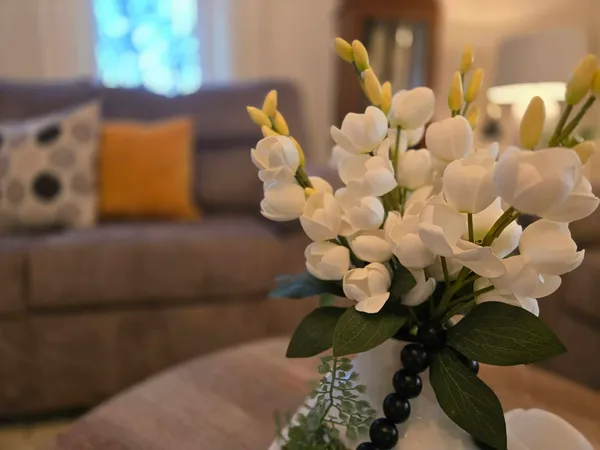 a bathroom with a lot of white flowers