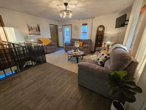 a living room with furniture fireplace and a window