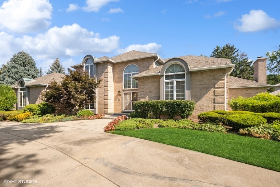 14 Kimberley Circle Oak Brook, IL 60523 - Photo 13 of 17 a front view of a house with a yard