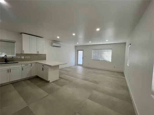 a large white kitchen with a white cabinets