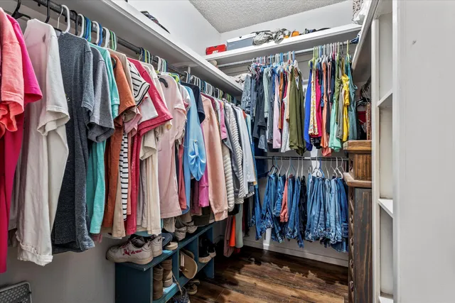 a view of walk in closet with clothes